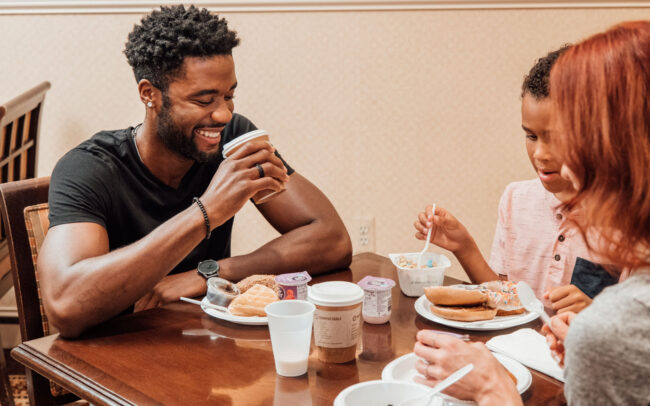 family smiling while eating breakfast at regent hotel